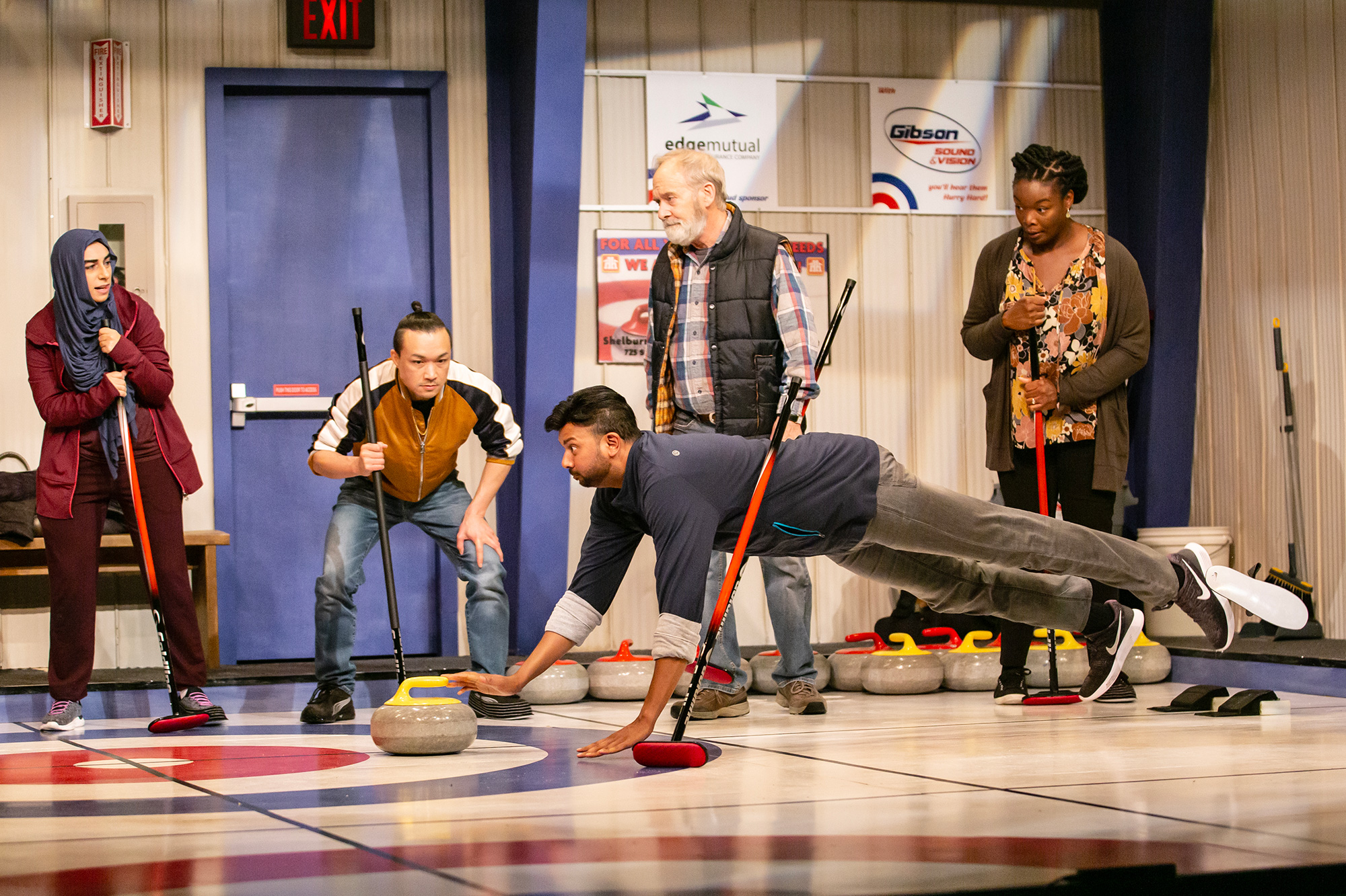 Zaynna Khalife, Norman Yeung, Andrew Prashad, John Jarvis, and Chiamaka Glory in The New Canadian Curling Club, Drayton Entertainment, 2023 Season. Directed by Jane Spence; Set Design by Beckie Morris; Costume Design by Alex Amini; Lighting Design by Jeff JohnstonCollins; Stage Manager Grace Batten; Assistant Stage Manager Rebecca Miller; Photography by Jenni Grandfield.